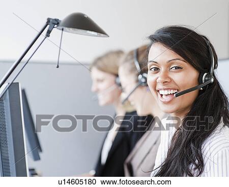 Stock Image - Woman wearing headset. Fotosearch