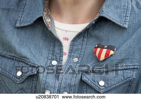 Stock Image - Woman wearing heart pin. Fotosearch