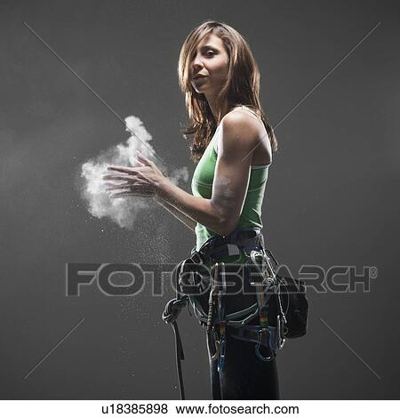 Woman with climbing gear putting chalk on hands View Large Photo Image Stock Photo - Woman with climbing gear putting chalk on hands. Fotosearch
