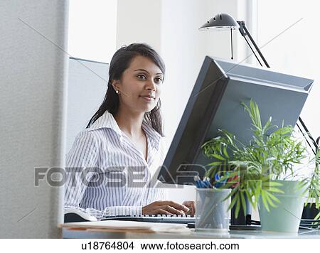 Picture - Woman working on computer. Fotosearch