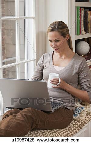 Woman working on laptop View Large Photo Image Stock Photo - Woman working on laptop. Fotosearch