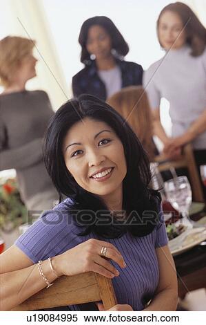Stock Photography - Women at dinner party. Fotosearch