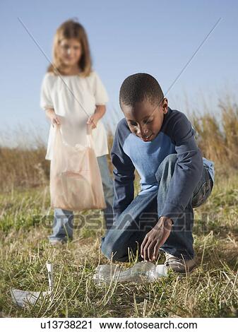 Young children picking up litter View Large Photo Image Stock Image - Young children picking up litter. Fotosearch