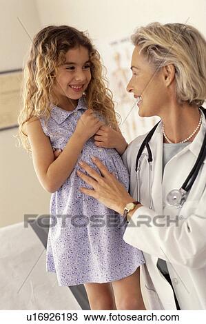 Stock Image - Young girl at doctors checkup. Fotosearch