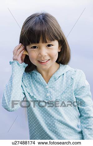 Young girl holding seashell View Large Photo Image Picture - Young girl holding seashell. Fotosearch