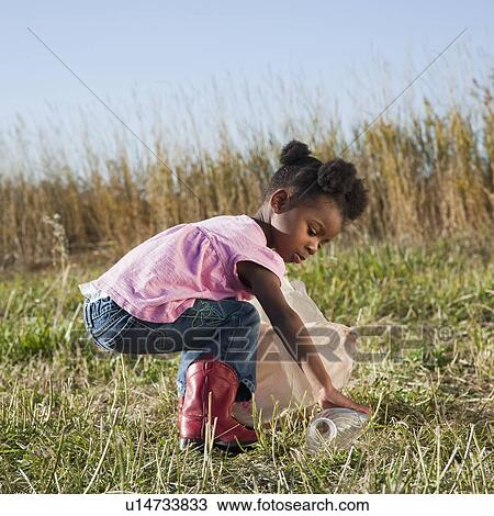 Young girl picking up litter View Large Photo Image Stock Image - Young girl picking up litter. Fotosearch