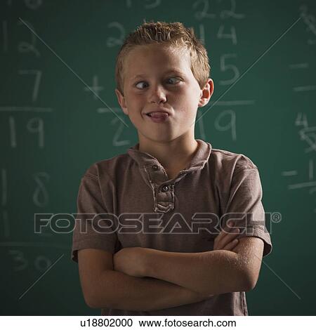Stock Image - Young student in classroom. Fotosearch