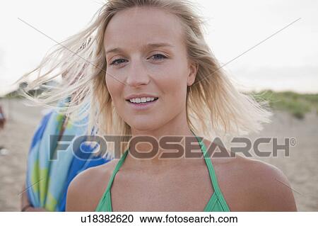 Young woman at the beach View Large Photo Image Stock Image - Young woman at the beach. Fotosearch