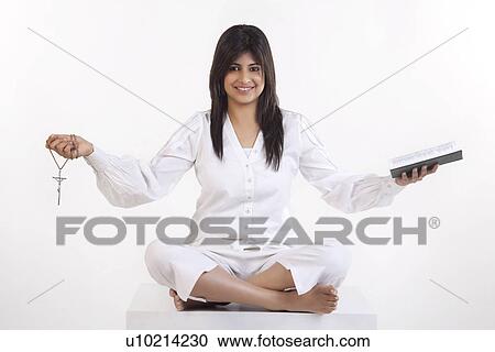 Stock Image - A Christian woman holding the Bible. Fotosearch