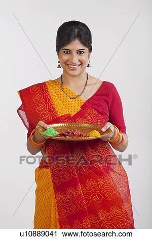 Stock Image - A Rajasthani woman holding a tray. Fotosearch