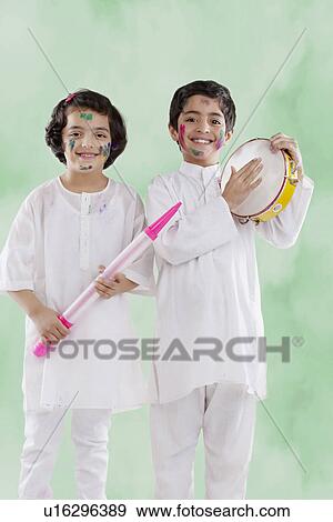 Stock Photo - Boy and girl enjoying holi. Fotosearch