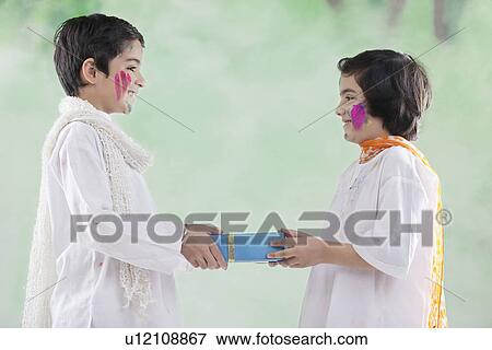 Stock Photo - Boy and girl exchanging gifts. Fotosearch