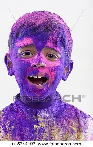 Stock Image - Boy covered all over with holi colours. Fotosearch