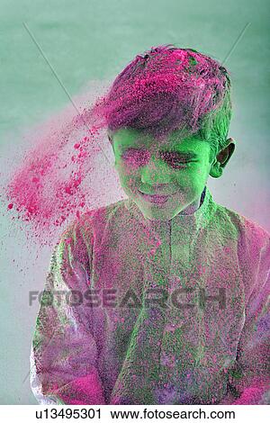 Stock Image - Boy covered with holi colour. Fotosearch