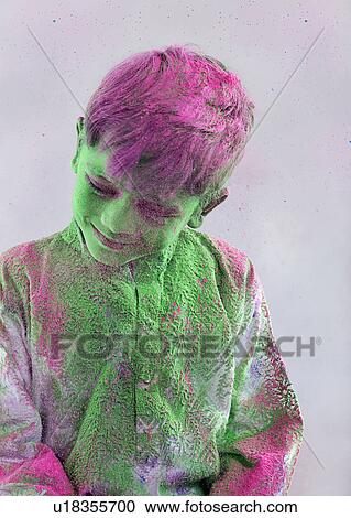 Stock Image - Boy covered with holi colour. Fotosearch