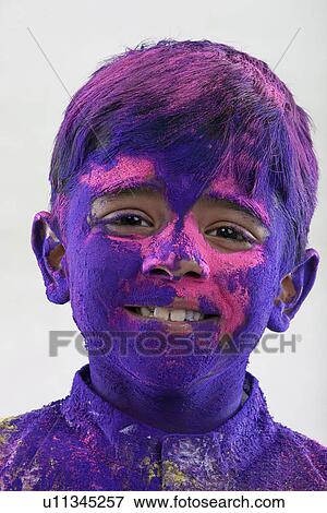 Stock Photo - Boy covered with holi colours. Fotosearch