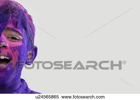 Stock Photography - Boy covered with holi colours. Fotosearch
