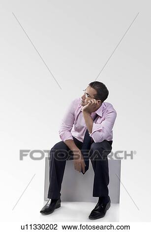 Stock Image - Businessman sitting. Fotosearch