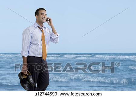 Stock Photo - Businessman talking on the beach. Fotosearch