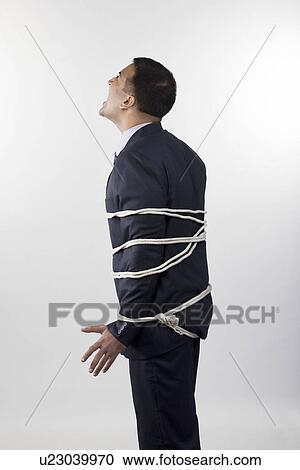 Businessman tied up with rope View Large Photo Image Stock Image - Businessman tied up with rope. Fotosearch