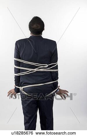 Businessman tied up with rope View Large Photo Image Stock Photograph - Businessman tied up with rope. Fotosearch