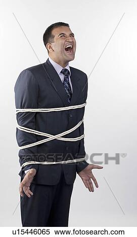Stock Photography - Businessman tied up with rope. Fotosearch