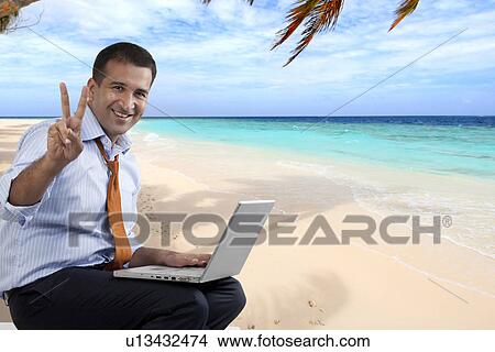 Businessman with a laptop at the beach View Large Photo Image Picture - Businessman with a laptop at the beach. Fotosearch
