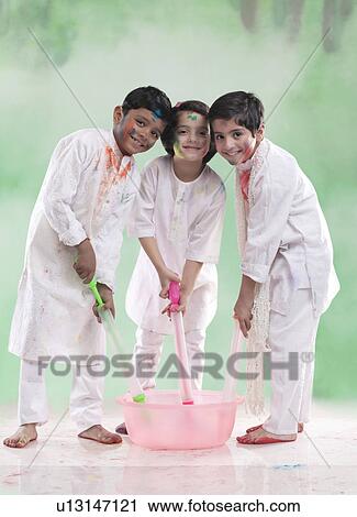 Children filling their pichkaris with water View Large Photo Image Stock Image - Children filling their pichkaris with water. Fotosearch