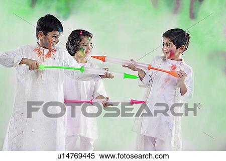 Stock Photography - Children playing with pichkaris. Fotosearch