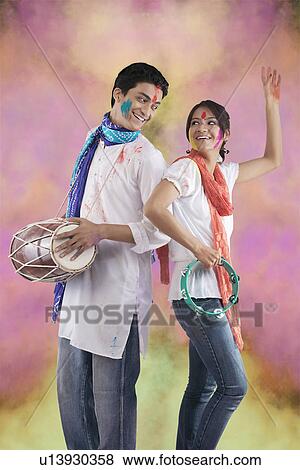 Stock Photo - Couple enjoying Holi. Fotosearch
