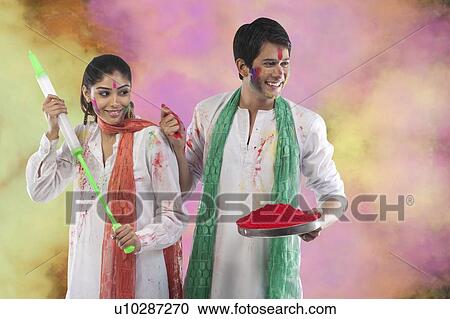 Couple playing holi View Large Photo Image Stock Image - Couple playing holi. Fotosearch