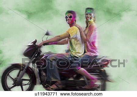 Stock Image - Couple riding on a motorcycle. Fotosearch