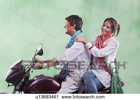 Stock Image - Couple riding on a motorcycle. Fotosearch