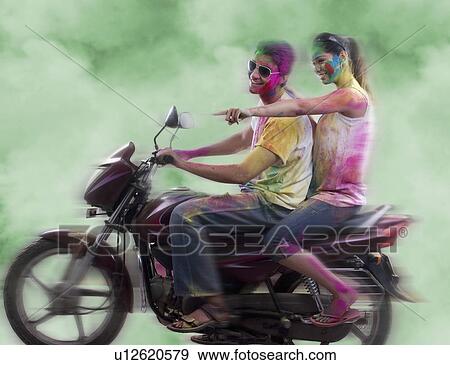 Couple riding on a motorcycle View Large Photo Image Stock Photo - Couple riding on a motorcycle. Fotosearch