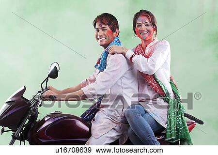 Couple riding on a motorcycle View Large Photo Image Stock Photo - Couple riding on a motorcycle. Fotosearch