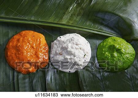 Stock Image - Different coloured chutney. Fotosearch