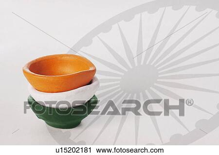 Stock Image - Different coloured diyas. Fotosearch