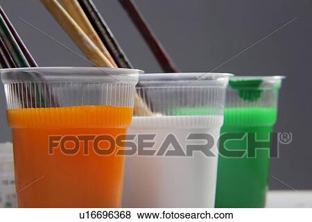Stock Photo - Different coloured paints in glasses. Fotosearch