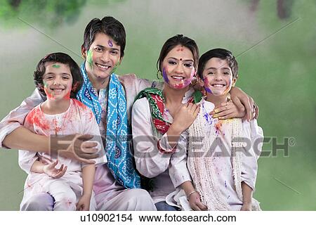 Picture - Family posing after playing holi. Fotosearch