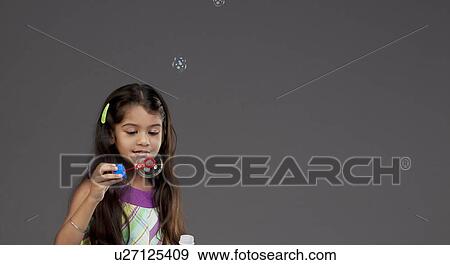 Girl blowing bubbles View Large Photo Image Stock Photo - Girl blowing bubbles. Fotosearch