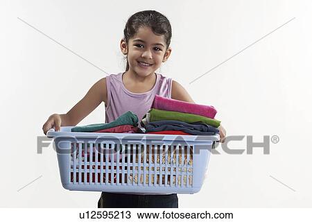 Stock Image - Girl carrying laundry basket. Fotosearch