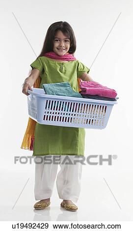 Girl carrying laundry basket View Large Photo Image Stock Photo - Girl carrying laundry basket. Fotosearch