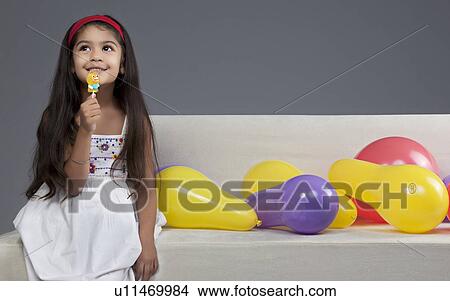 Girl having a lollipop View Large Photo Image Picture - Girl having a lollipop. Fotosearch