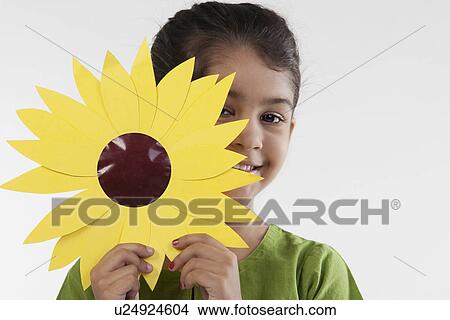 Girl holding a paper flower View Large Photo Image Picture - Girl holding a paper flower. Fotosearch