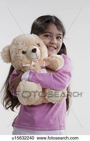 Stock Image - Girl holding a teddy bear. Fotosearch