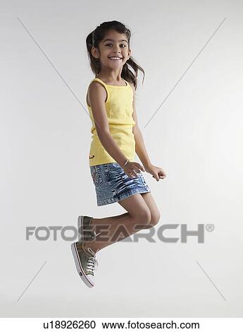 Girl jumping in the air View Large Photo Image Stock Image - Girl jumping in the air. Fotosearch