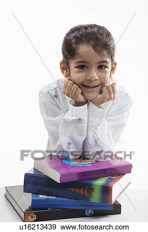 Stock Photo - Girl leaning on a stack of books. Fotosearch