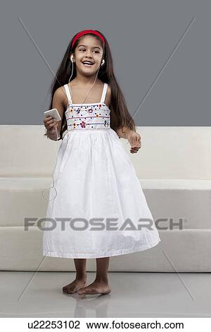 Stock Image - Girl listening to music. Fotosearch
