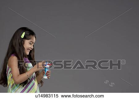 Girl playing with bubbles View Large Photo Image Stock Photography - Girl playing with bubbles. Fotosearch