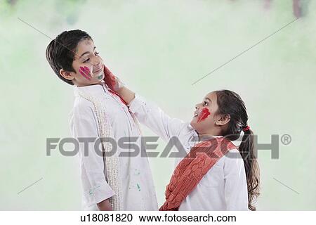 Girl putting colour on a boy's face View Large Photo Image Stock Image - Girl putting colour on a boy's face. Fotosearch